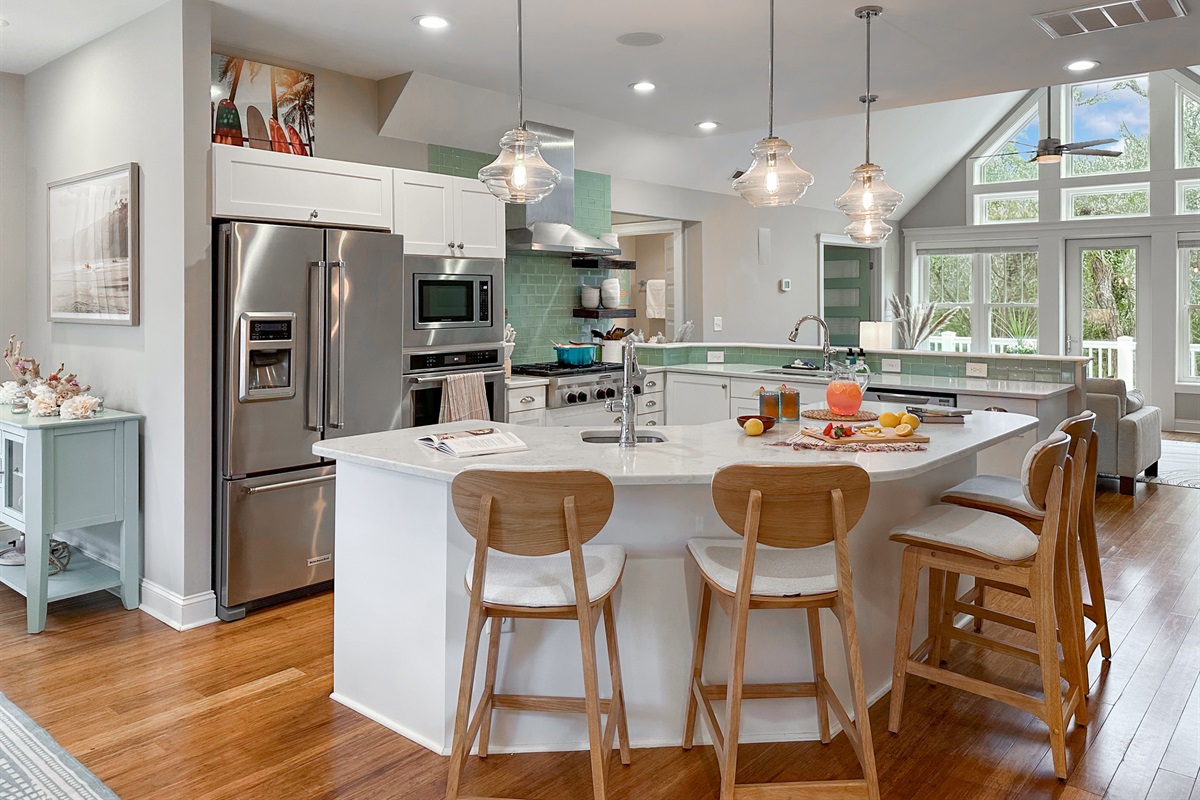 The fully stocked Kitchen comes with stainless steel appliances and an island with extra seating...