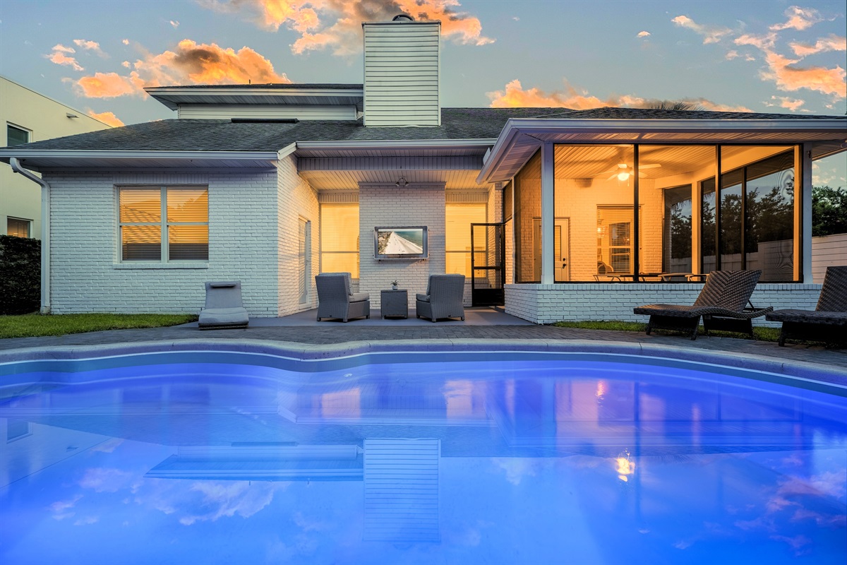 Backyard oasis with sparkling heated pool and covered lounge