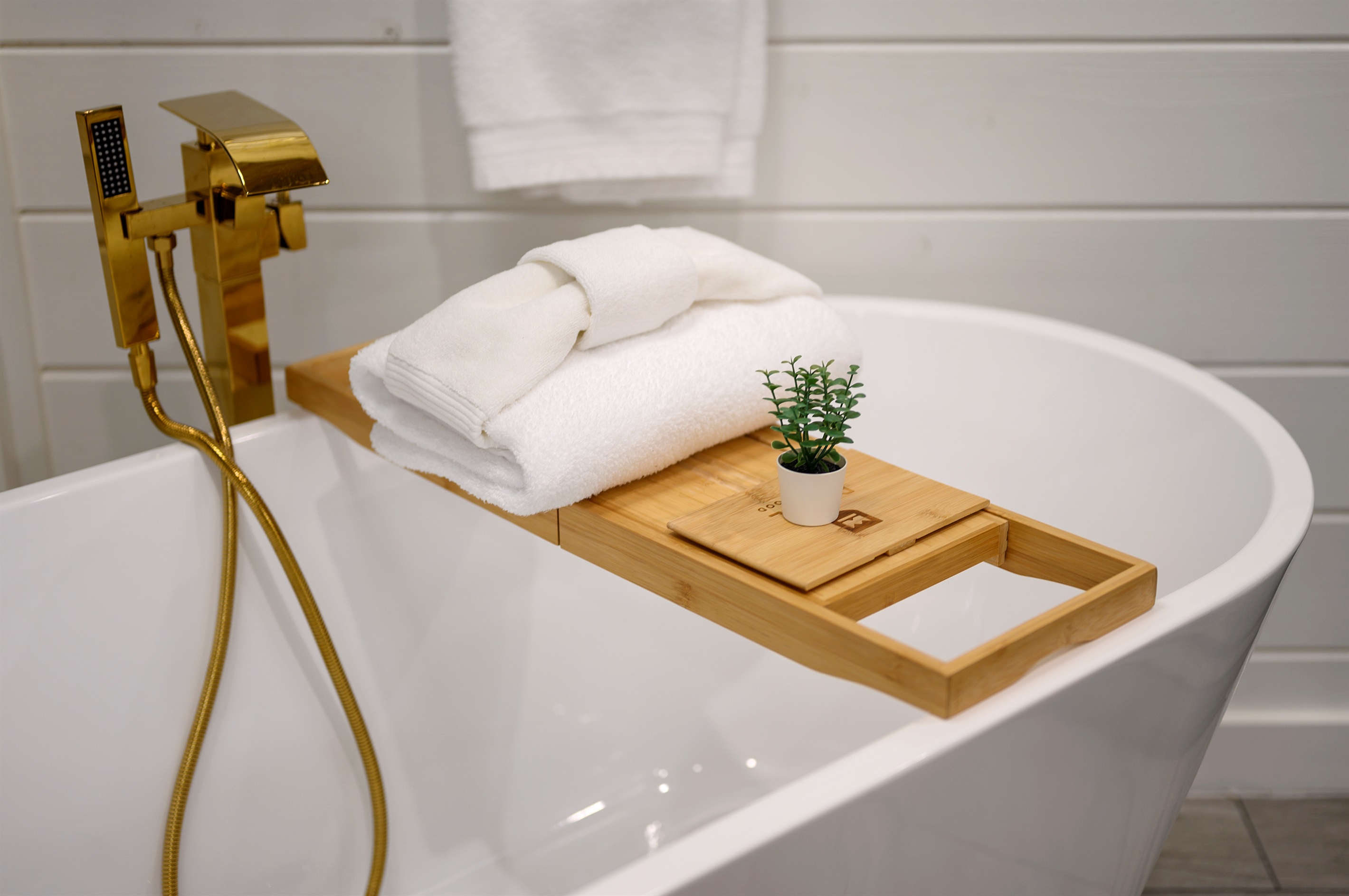 A full bathroom with a deep soaking tub and bathtub tray, perfect for long, relaxing baths and slow unwinding.