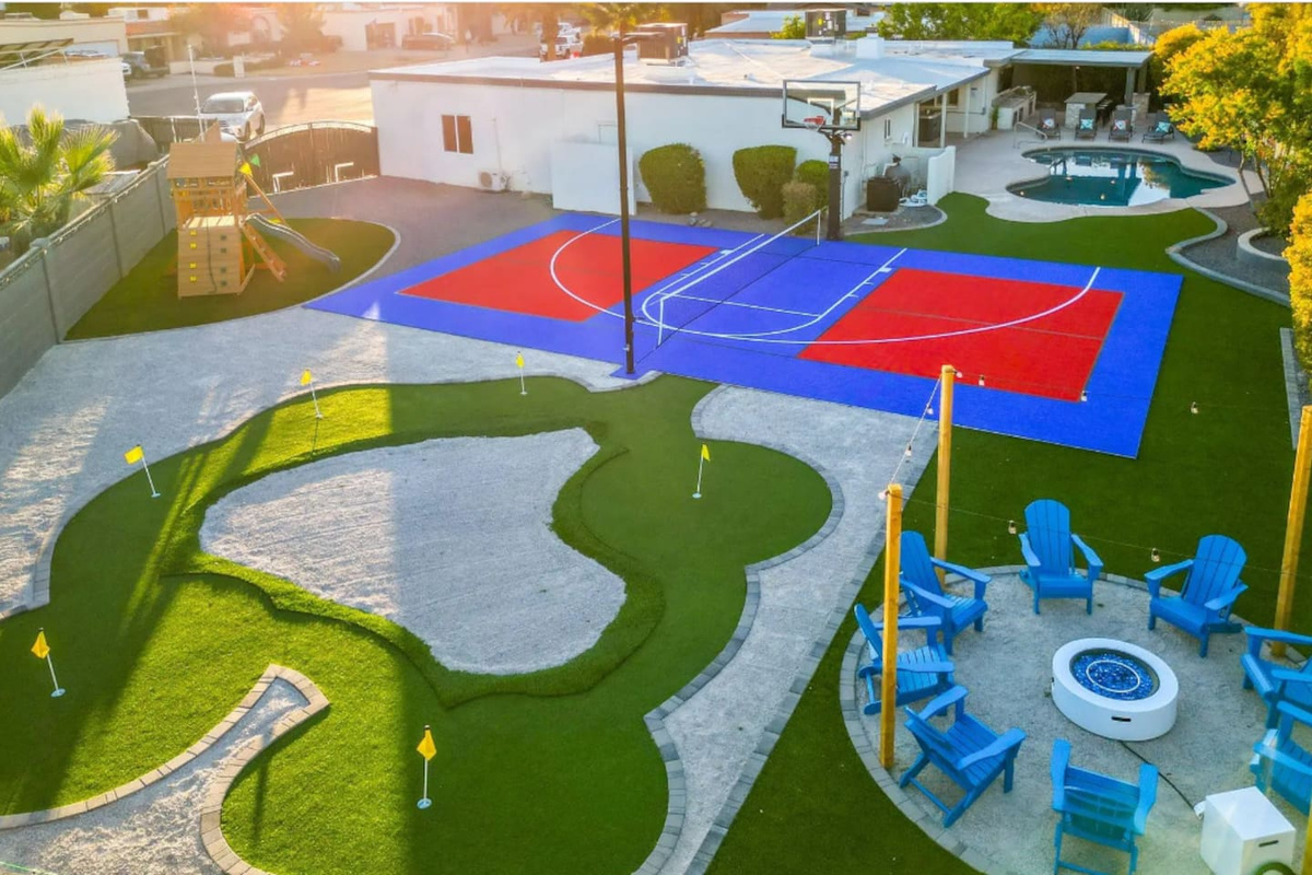 From above, the backyard reveals just how much this property has to offer: a full sport court, a putting course, and a fire pit lounge all within steps of each other.