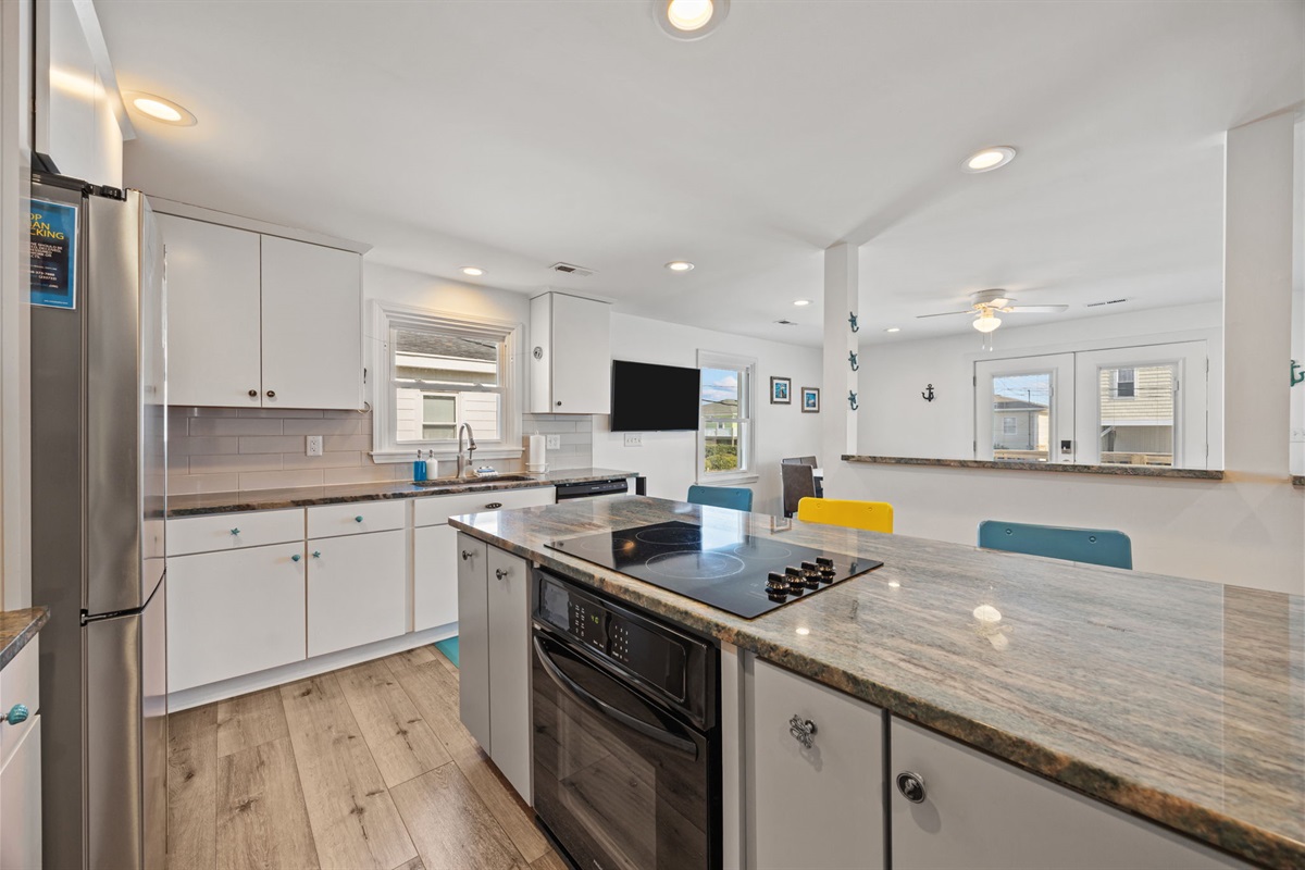 Open kitchen layout with island seating and a direct connection to the living space