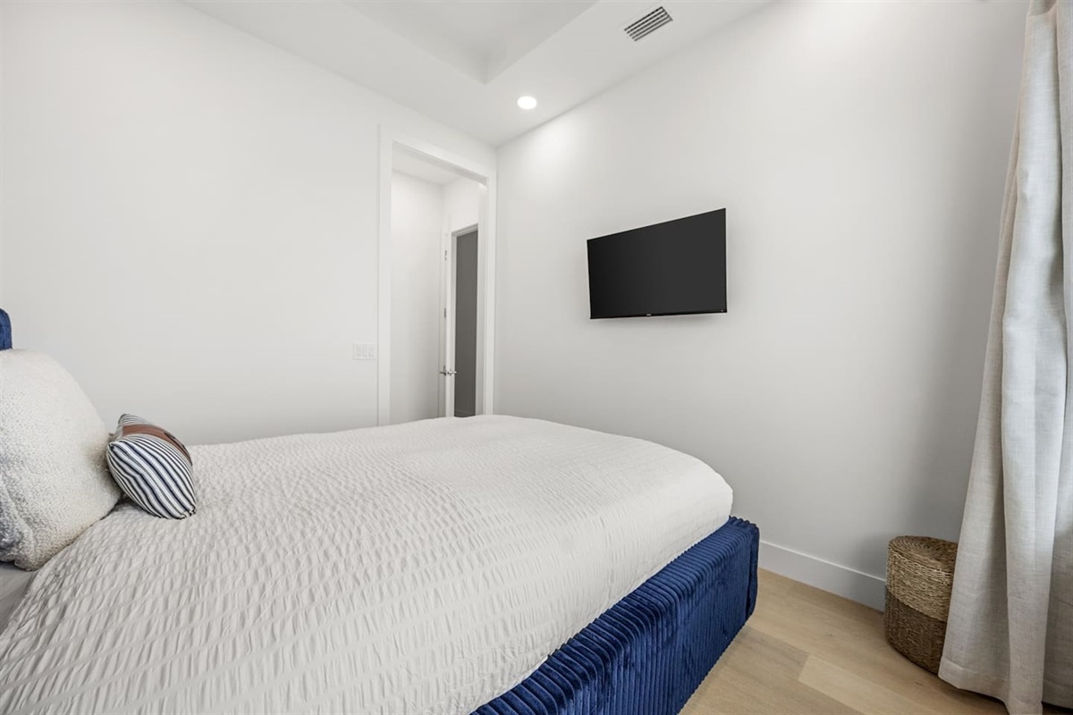 This bedroom features a TV, providing a comfortable space for relaxation and entertainment at the end of the day.