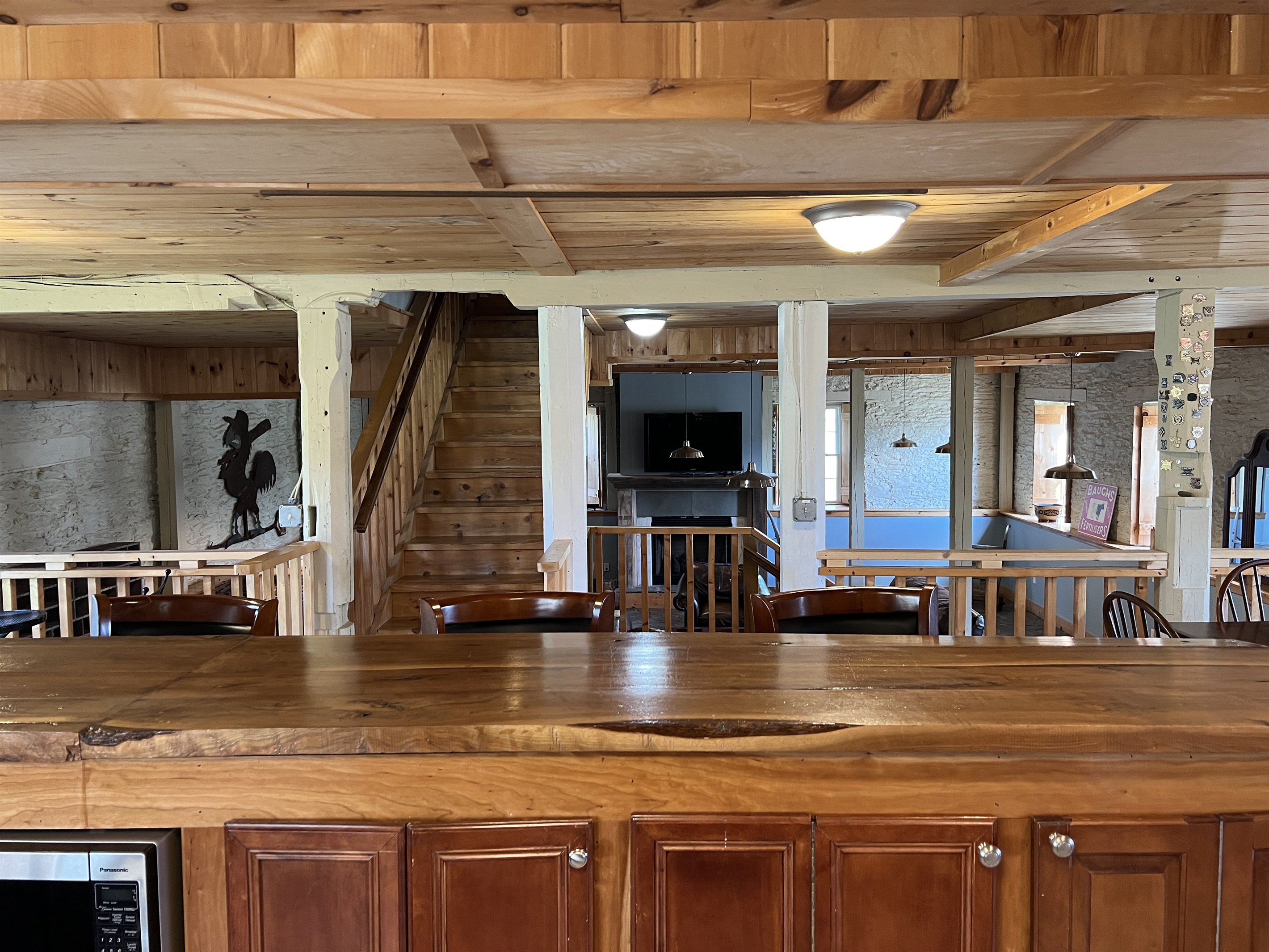 Kitchen, living room beyond with stairs to 2nd floor.