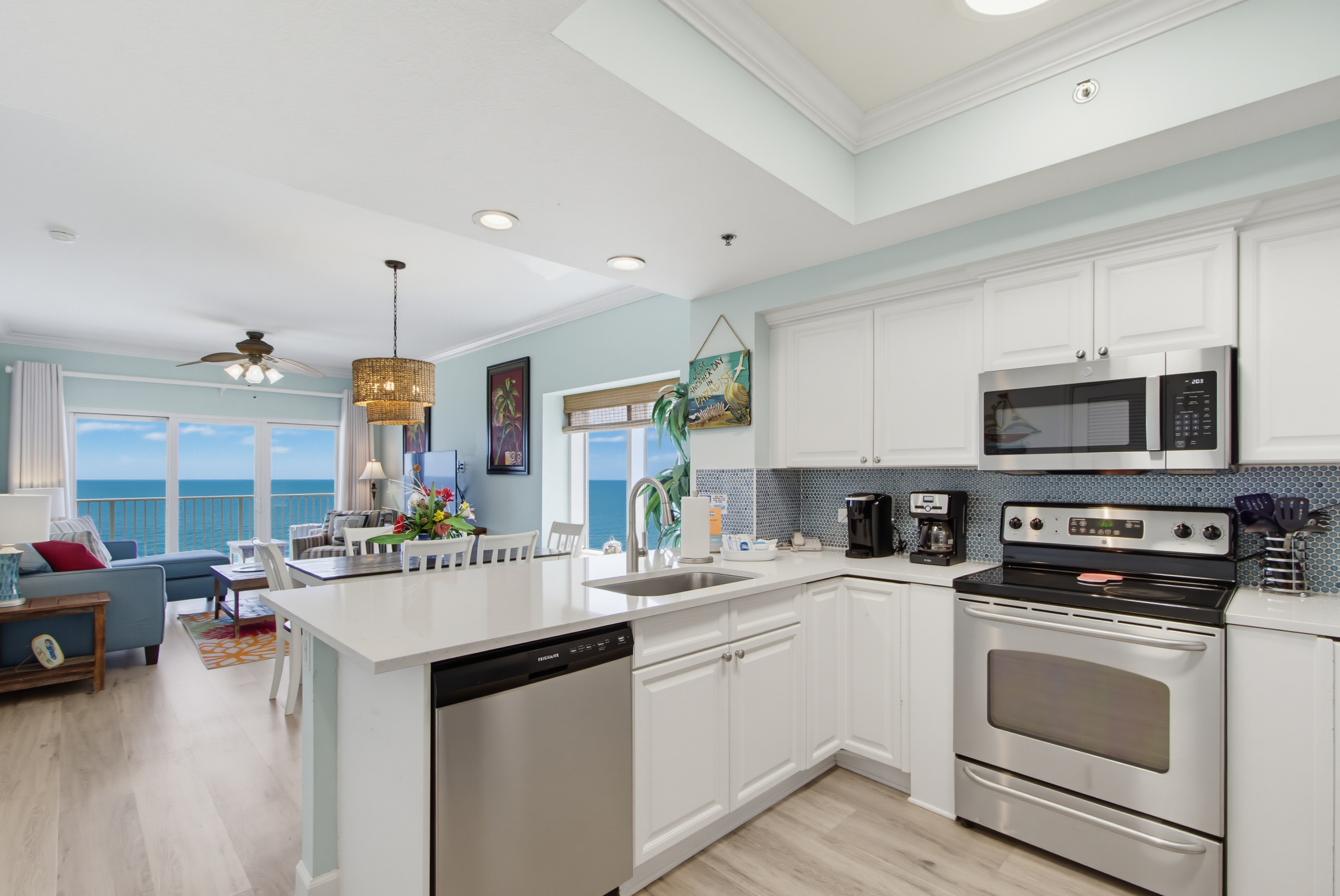 Open kitchen with stainless-steel appliances and Gulf views beyond.