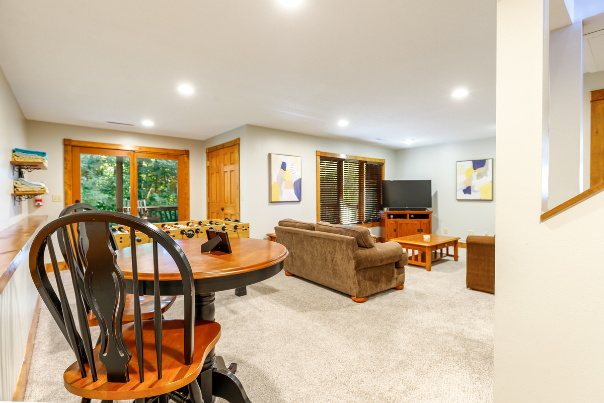 Lowev level living room with Smart TV and foosball table