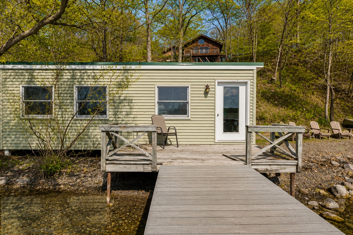Lakefront / Boathouse / Dock (requires three flights of stairs to access) -  Enjoy direct lake access from this cozy lakeside cabin, complete with a private deck for relaxing by the water. Ideal for a serene, natural escape.