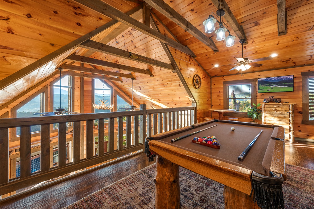 The open loft is a great hang out for kids and adults. Pool table, smart TV, and GIANT arcade.