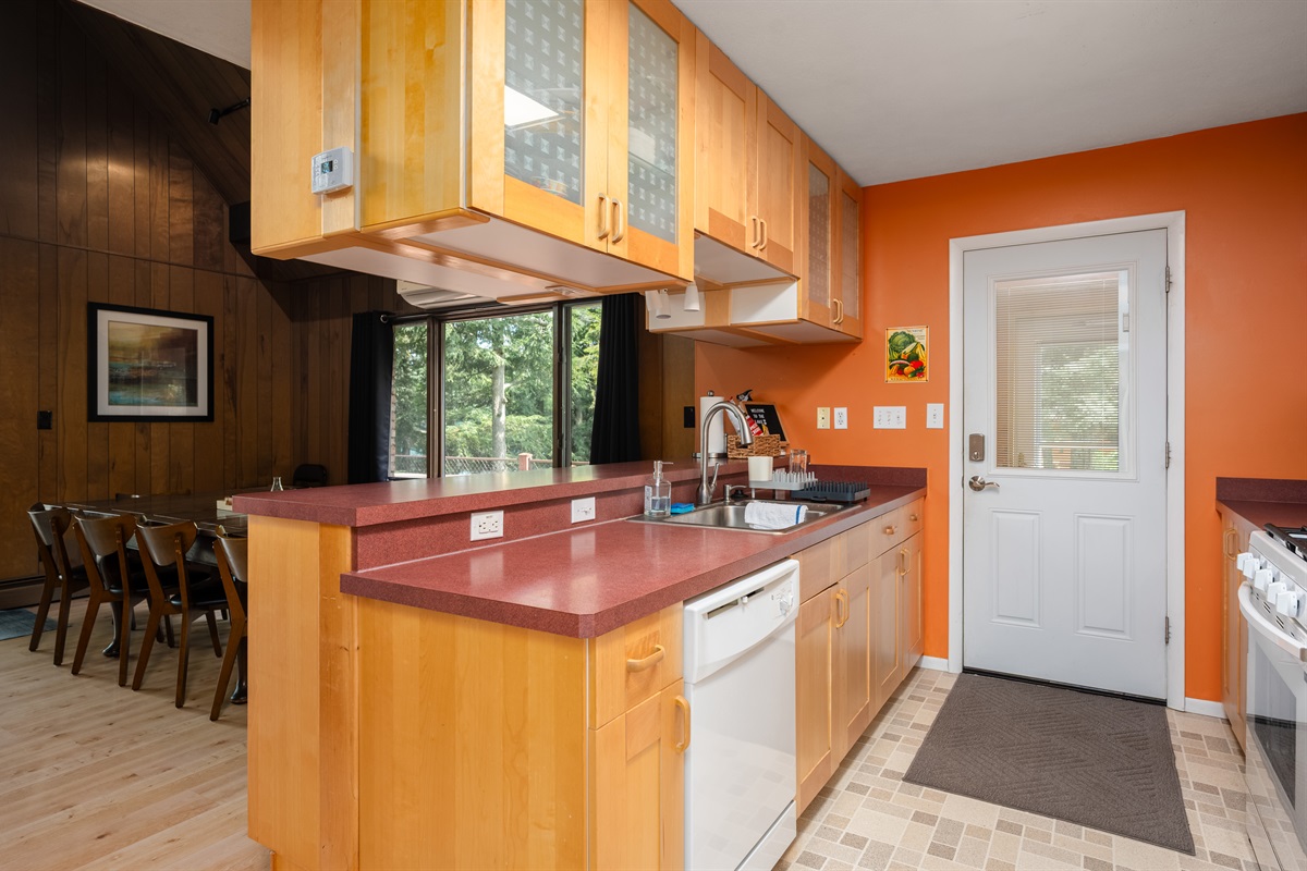 Kitchen with wood cabinetry and appliances