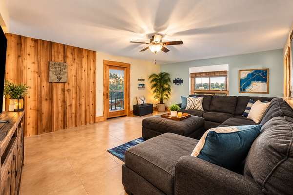 Spacious lower-level living room with an oversized, high-quality sectional designed for serious comfort. There’s plenty of room for the whole group to stretch out, relax after a day on the lake, watch a movie, or simply spend time together. A comfortable s