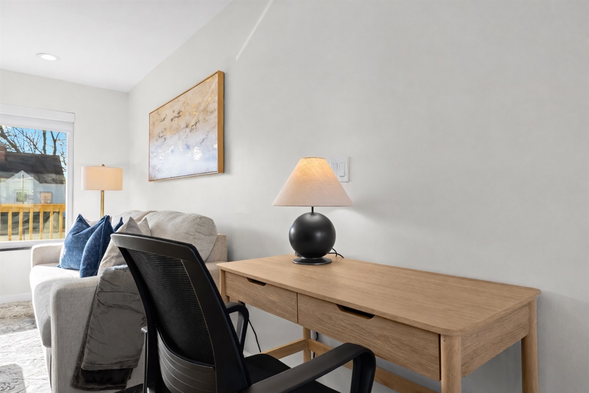 Dedicated workspace with a comfortable desk and chair, natural light, and a quiet setting—perfect for remote work or focused productivity.