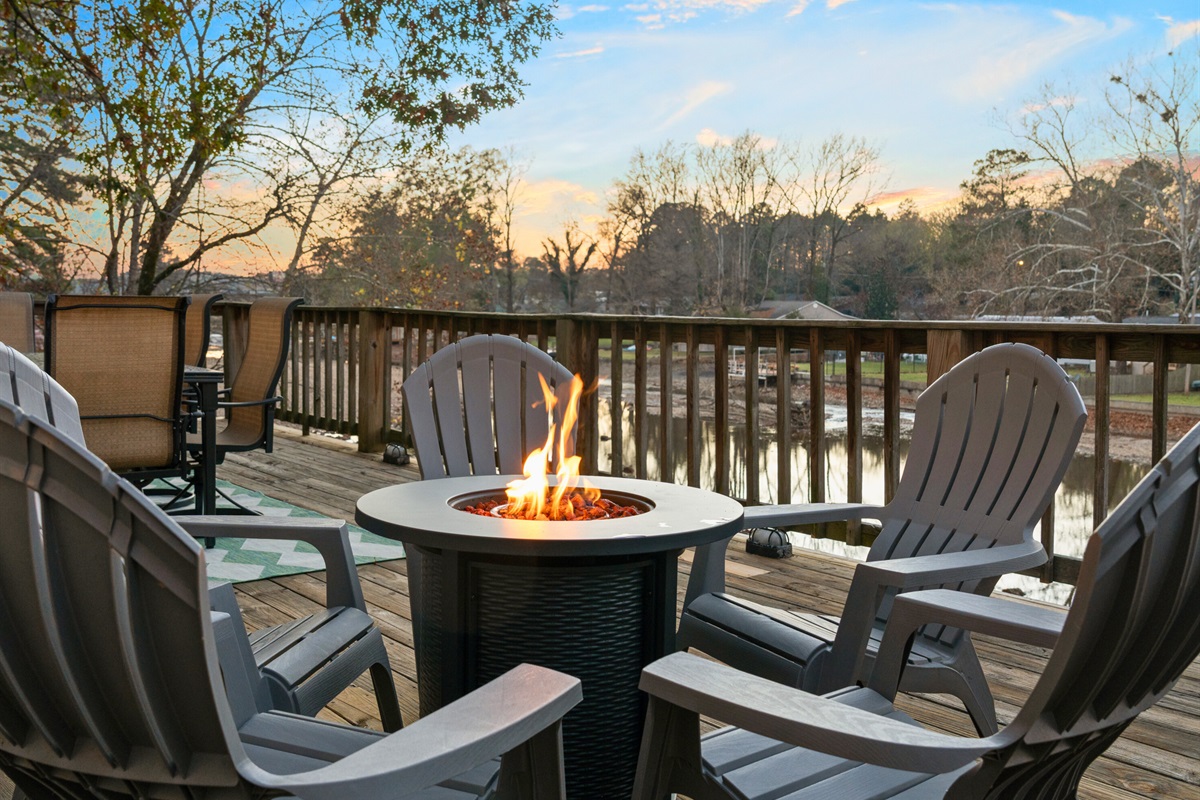 Cozy Adirondack chairs and a glowing firepit create an unforgettable place to take in the sunset over the lake.