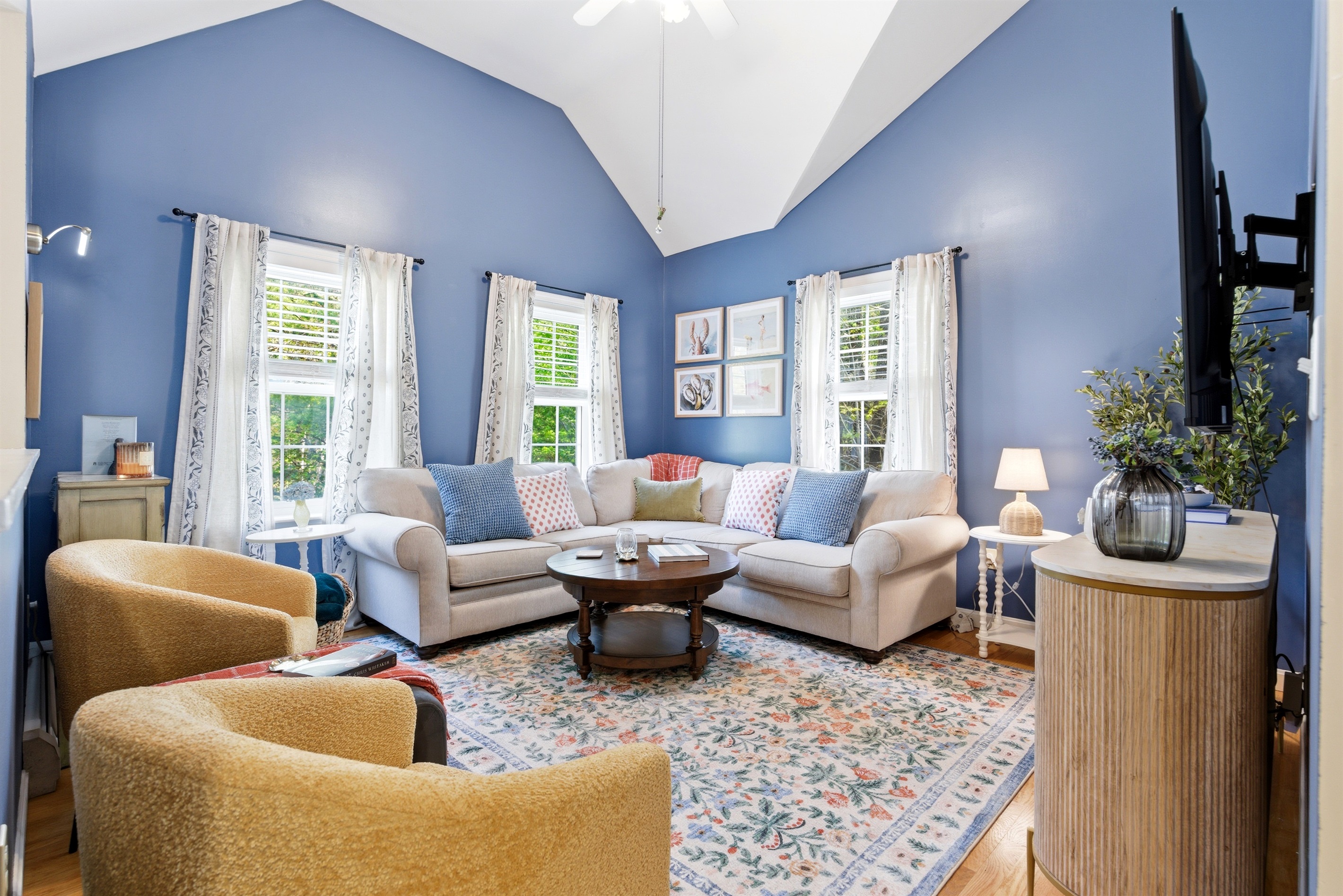 A bright and spacious living room filled with natural light from large windows, creating an open and inviting atmosphere for relaxing and gathering.