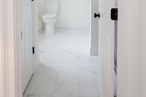 The spacious "sunrider room" features two queen beds, a spacious double-door closet, a full bath with a shower, smart TV and coastal photography. 