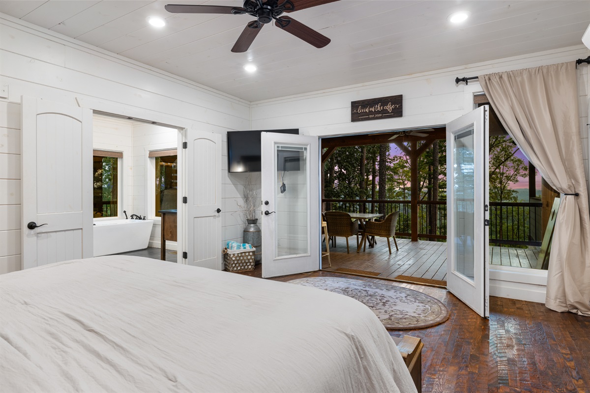 Peaceful bedroom retreat with private deck access and beautiful outdoor scenery