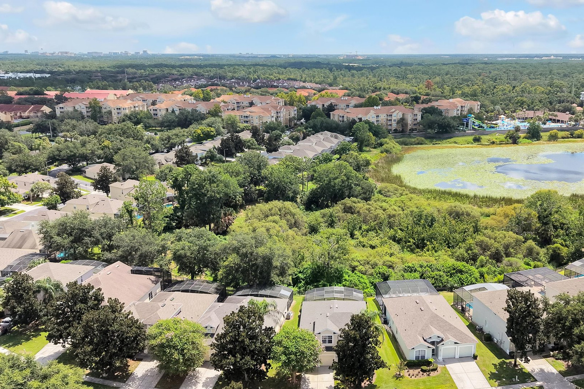 Motunui Villa Aerial: Motunui Villa backs onto peaceful conservation, with Reedy Lake and the Windsor Hills clubhouse and waterpark visible beyond.