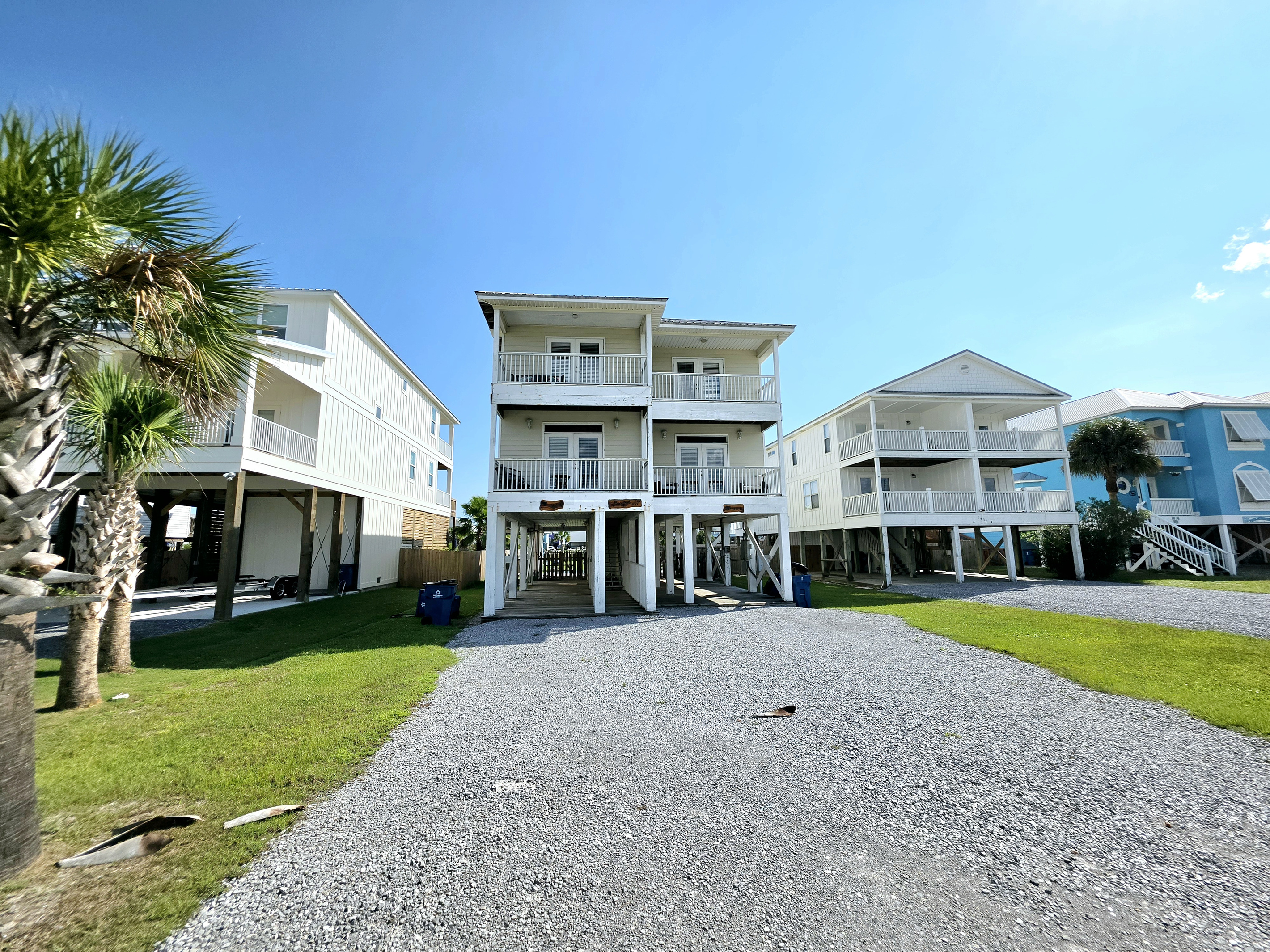 Turtles Nest Unit B – elevated home on West Lagoon Ave with gravel driveway