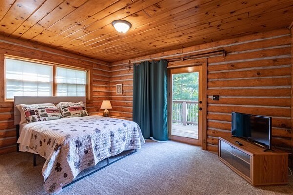 Bedroom 1  is located on the first floor overlooking the lake with your own door to sneak out for some early morning fishing on the dock.