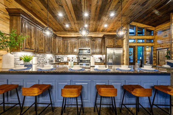 Cozy cabin kitchen with granite island, and plenty of seating area