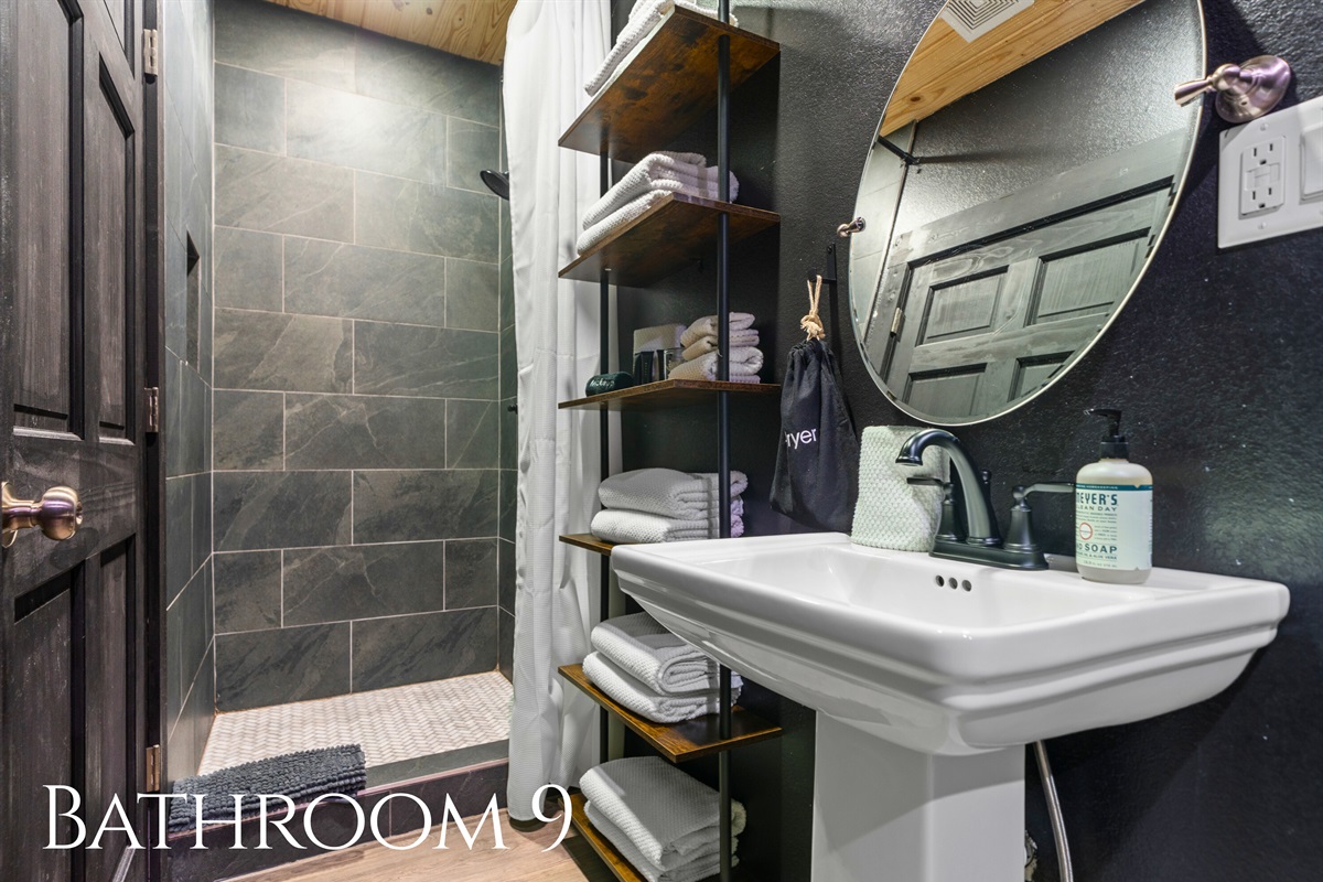 Bathroom 9 provides convenient access from the bunk room area and features a spacious shower and modern finishes.