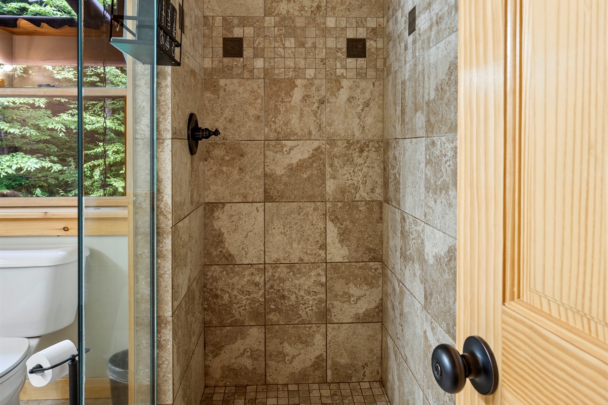 The bathroom includes a standing shower—simple, clean, and convenient.