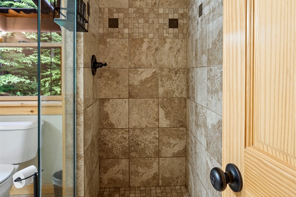The bathroom includes a standing shower—simple, clean, and convenient.