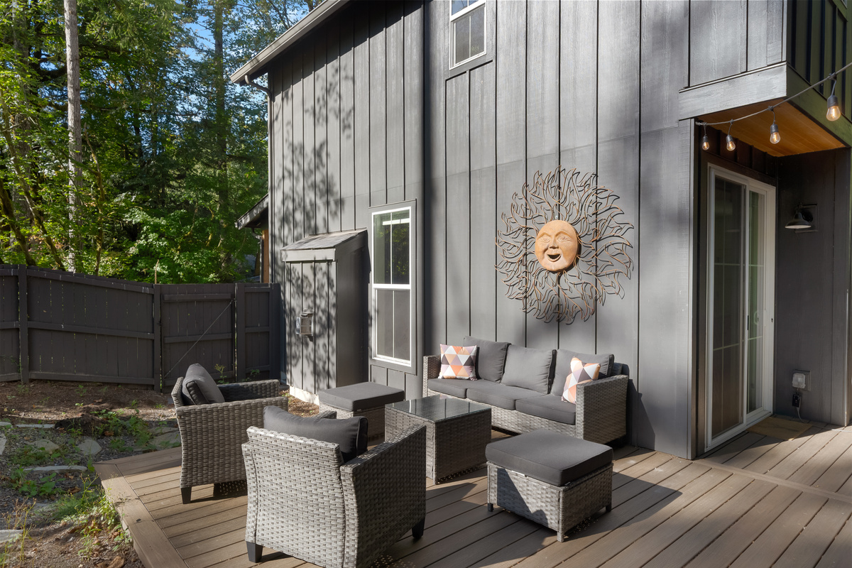 Lounge seating on a private deck, framed by cedar and fir.