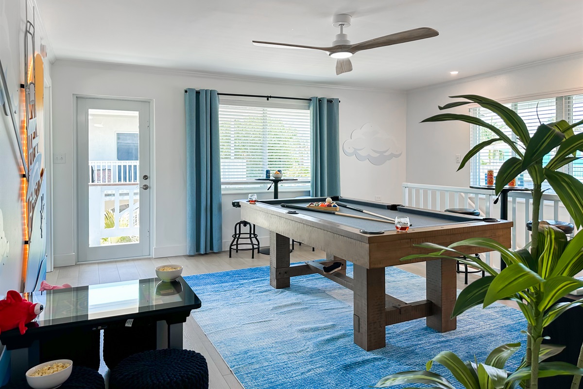 The stairs lead you up to the second game room where you can play a round on the pool table.