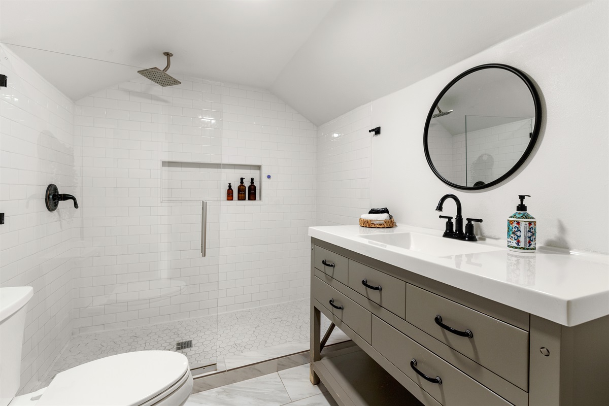 "From the gleam of the fixtures to the plush towels, this bathroom is a canvas of comfort and aesthetics."