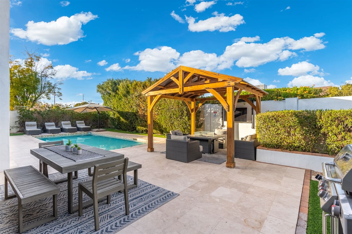 From the shaded gazebo with TV to the sleek grill and resort-style loungers, this backyard offers the full outdoor living package—comfort, style, and sunshine all in one place.