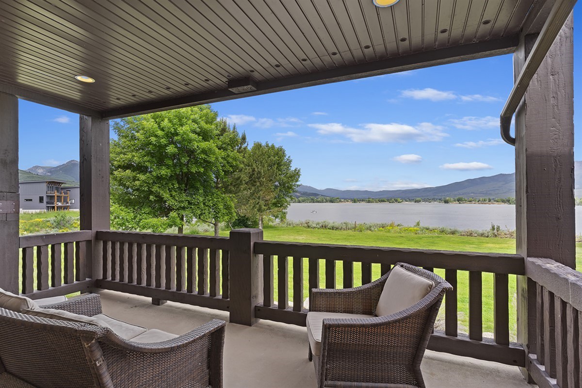 Private balcony with seating and peaceful lake views.