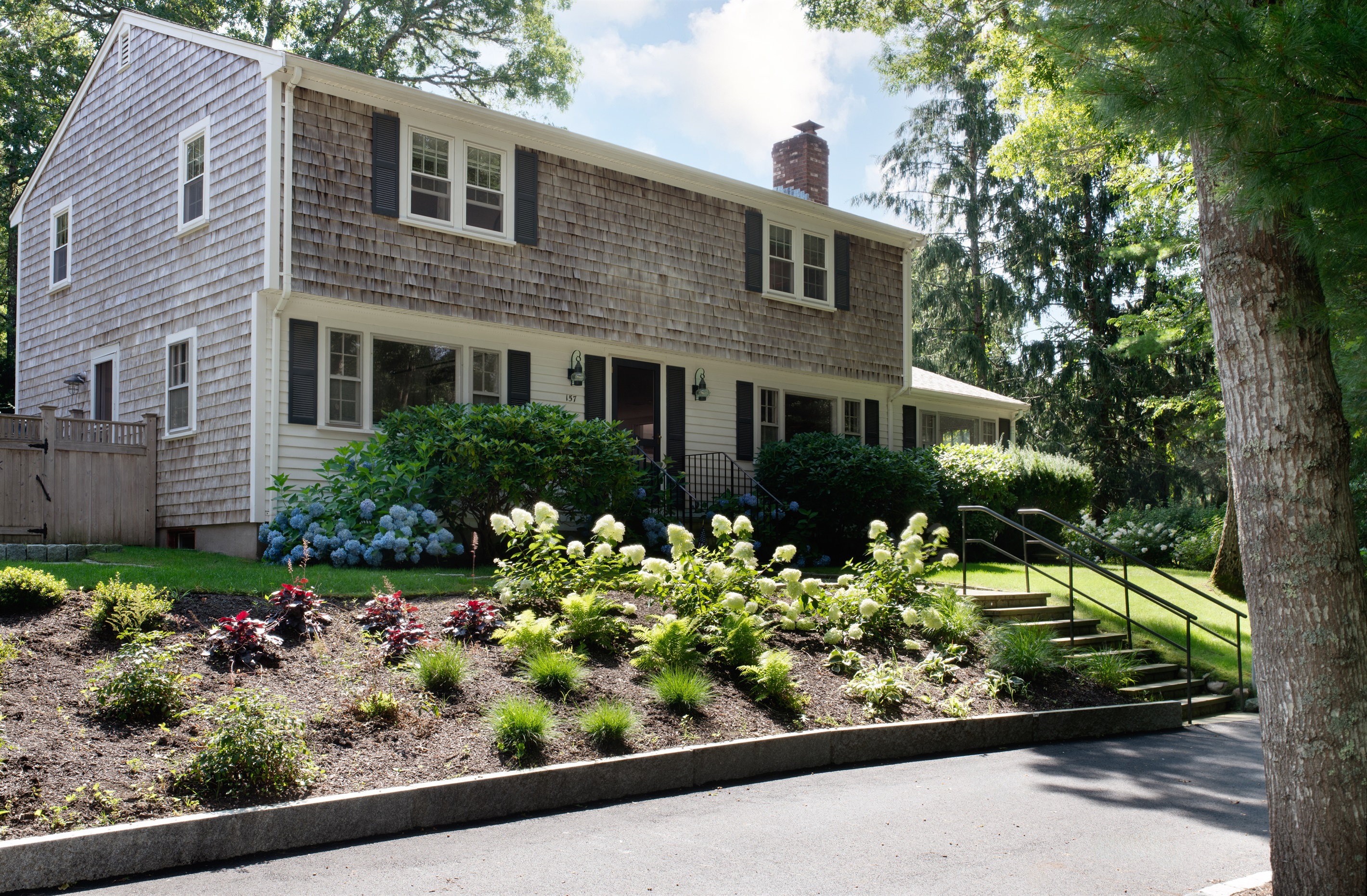 Enjoy the vibrant garden with green lawns and colorful flowers.