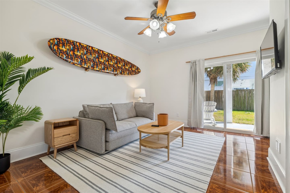 This room is located on the ground level, at the back of the home and functions as an extra living space with a tv, and also a bedroom with a private bathroom. This room also allows access to the backyard area. The sofa is a pullout.