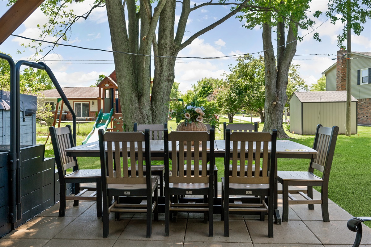 Spacious outdoor dining area with seating for 8 and a grill, perfect for family meals, cookouts, and enjoying the fresh air together.