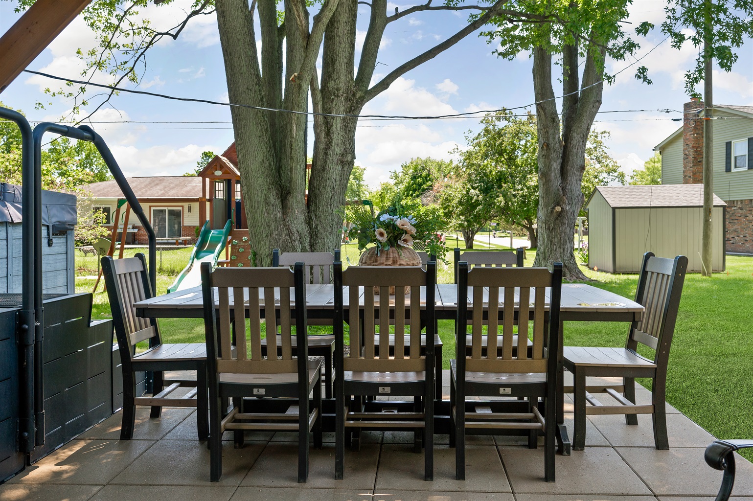 Spacious outdoor dining area with seating for 8 and a grill, perfect for family meals, cookouts, and enjoying the fresh air together.