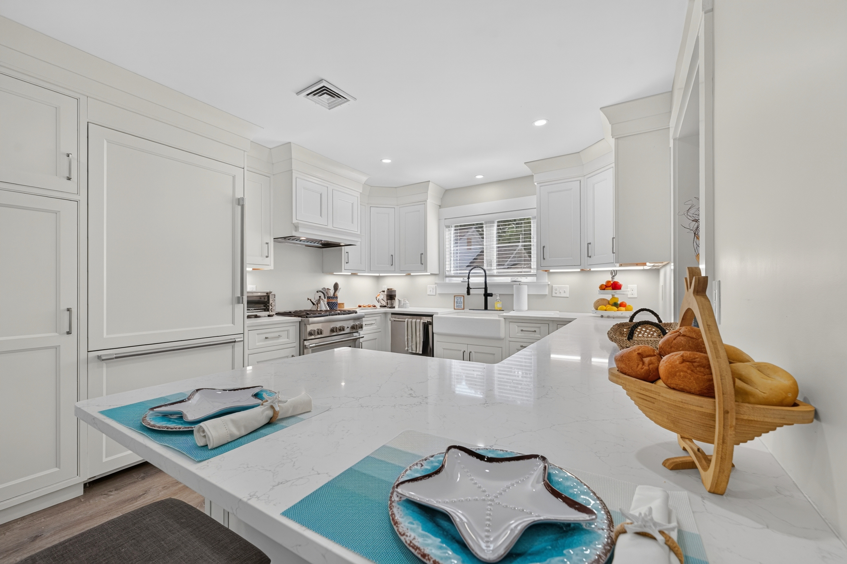 Spacious kitchen island offering additional prep space and a welcoming spot for conversation.