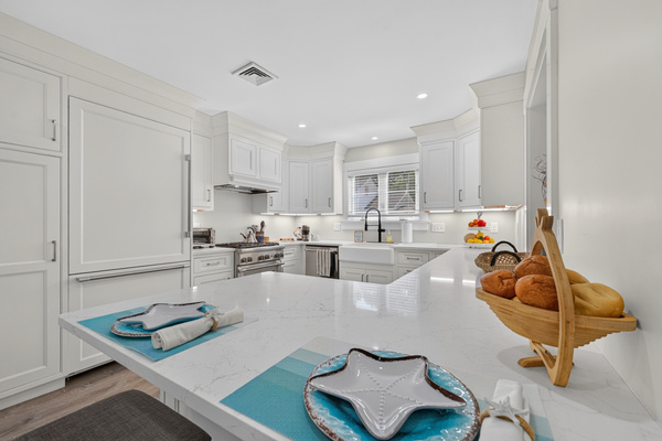 Spacious kitchen island offering additional prep space and a welcoming spot for conversation.