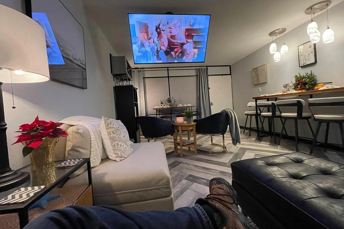 Living room area with large TV that will drop from the ceiling.