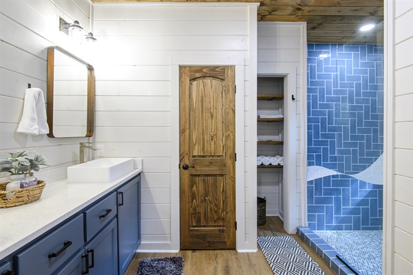 Beautiful bathroom with dual heads, reclined bench, dual sinks.