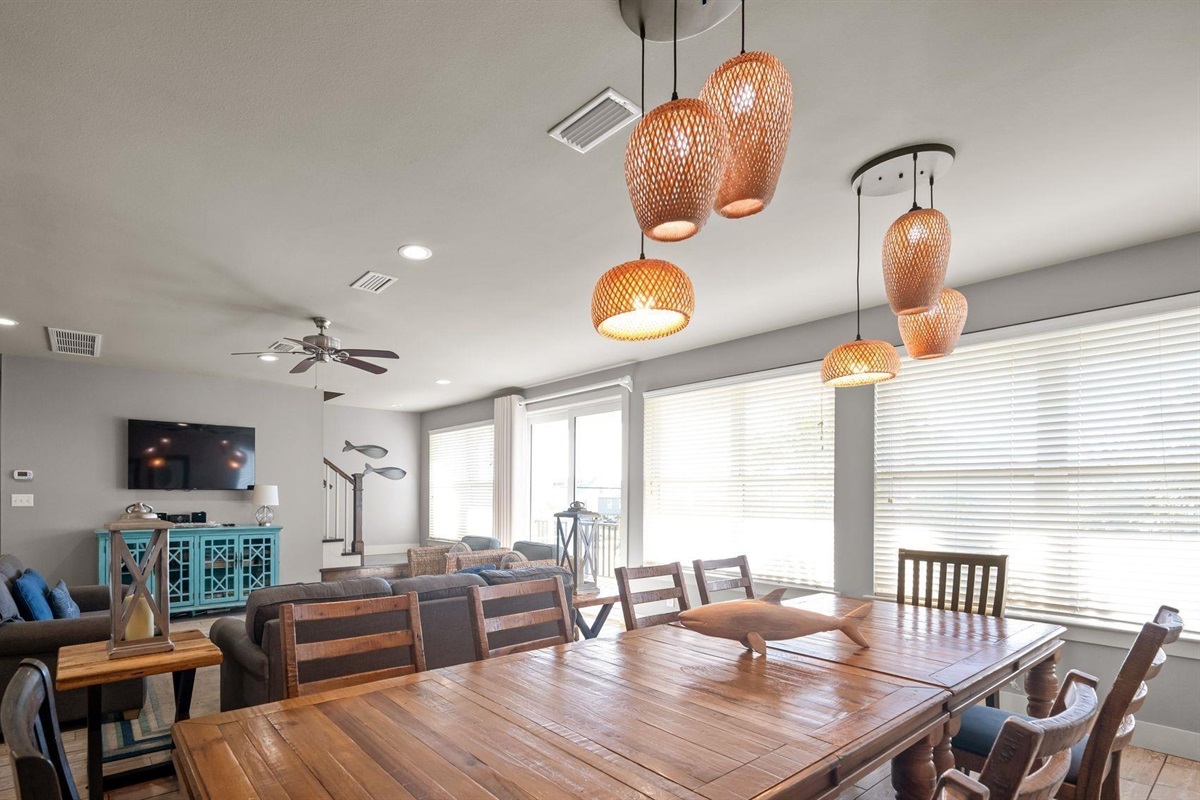Dining area with a table and chairs set for 8 and additional seating for 4 at the breakfast bar 