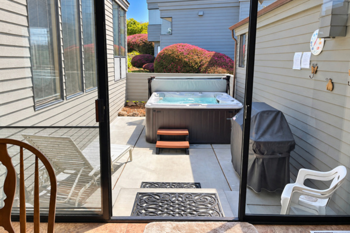 Patio with Sundance hot tub and propane Weber Barbecue with lounge chair