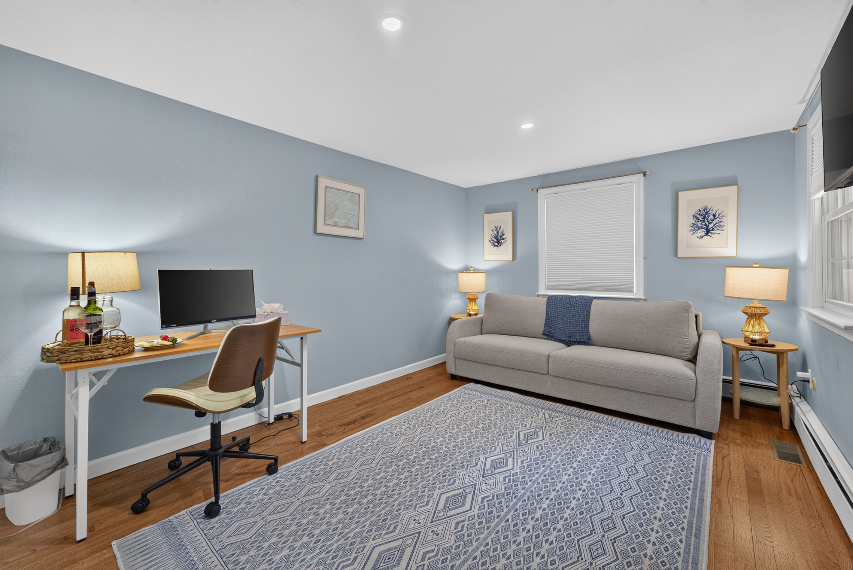 Thoughtfully furnished bedroom offering space to rest and stay productive.