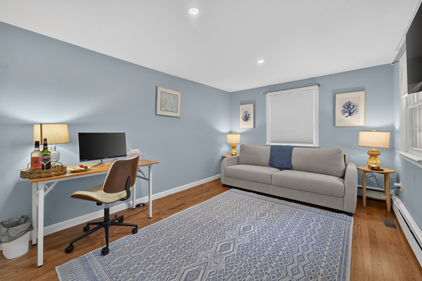 Thoughtfully furnished bedroom offering space to rest and stay productive.