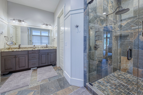 Spa-inspired primary bath featuring a spacious walk-in shower and double vanity