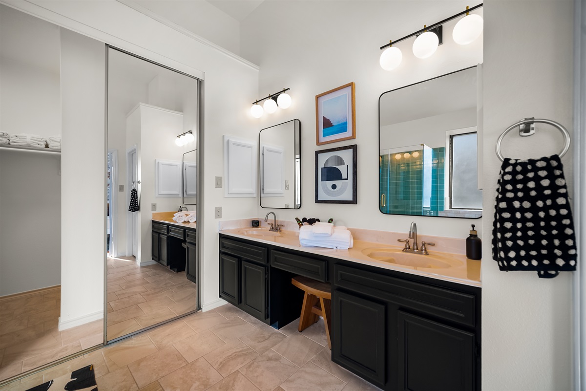 A spacious double vanity with a full-body mirror.