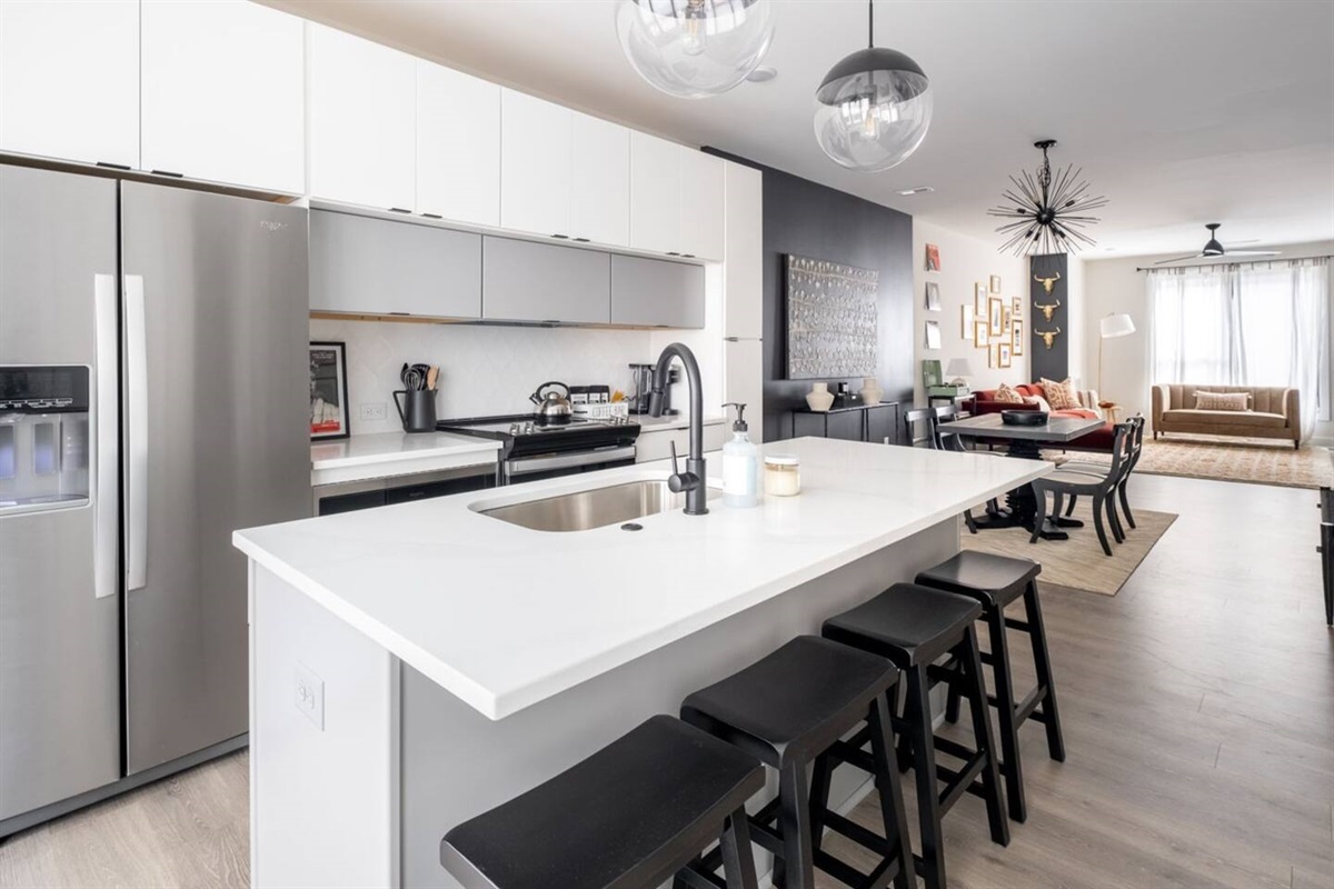 From the quartz countertops to the stainless appliances, every detail has been carefully curated to create a space that is both functional and beautiful. Fully stocked kitchen for cooking meals at home.
