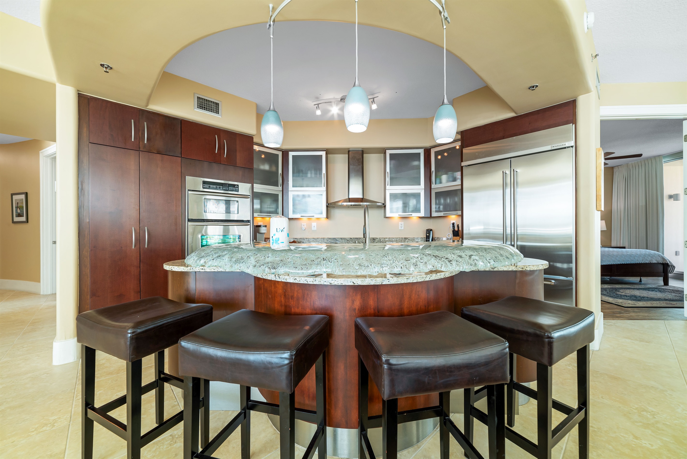 The modern kitchen island with bar seating offers a casual dining option, while the open layout maximizes natural light and showcases the stylish finishes throughout.