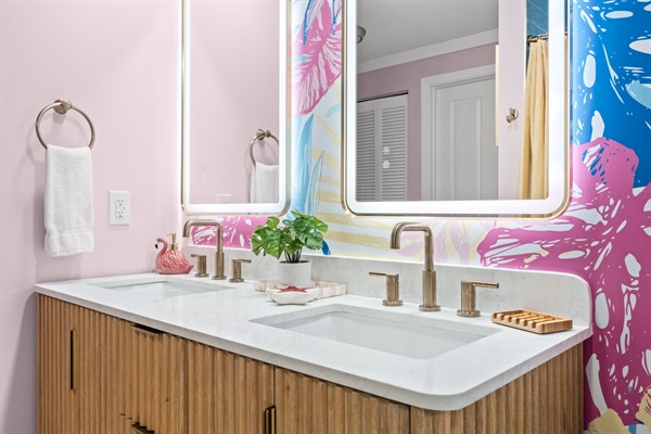 Fluted wood double vanity with quartz countertop and Delta fixtures