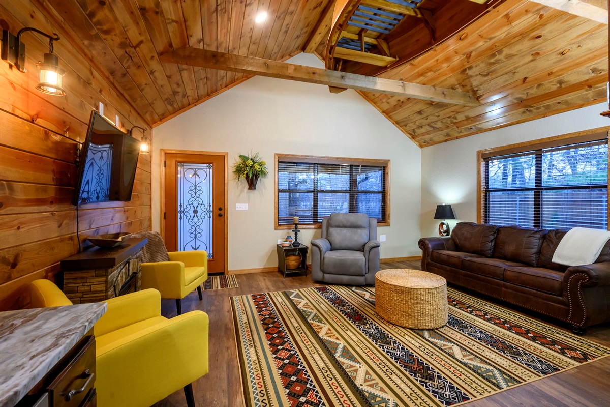 The living room with an electric fireplace and smart TV with cable provided.