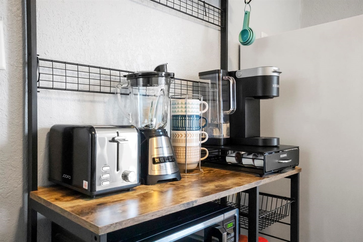 Cozy coffee nook equipped with mugs, a blender, and a toaster, perfect for enjoying a morning beverage or quick breakfast.