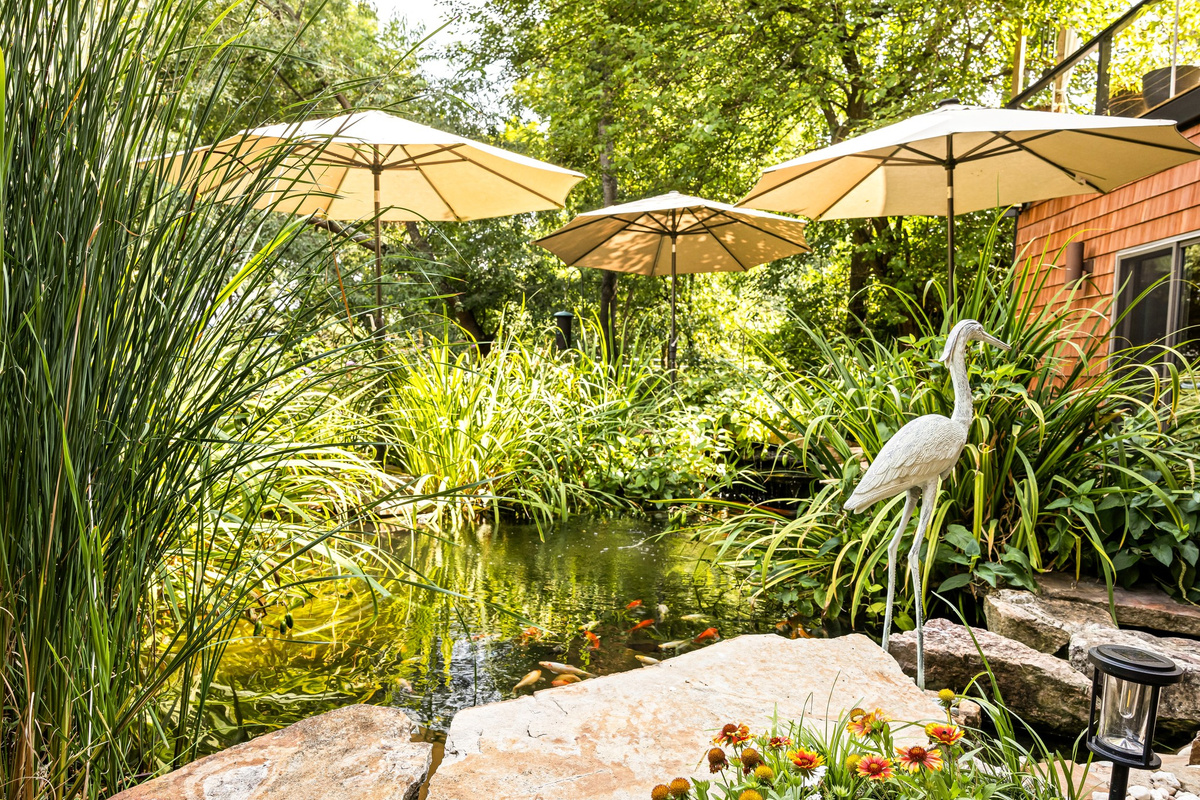 Meet Henrietta Heron, the garden statue guarding our signature 7,000-gallon Koi pond! Grab morning coffee, feed the fish, and experience why Hilltop Oasis Abingdon is truly a world away.